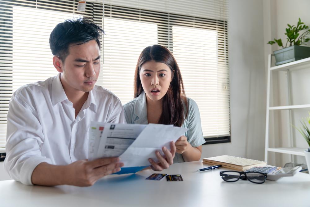 Stressed couple while looking at electrical bill